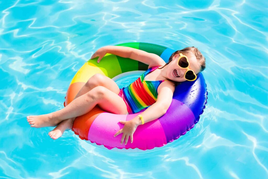 a little girl enjoying in a swimming pool