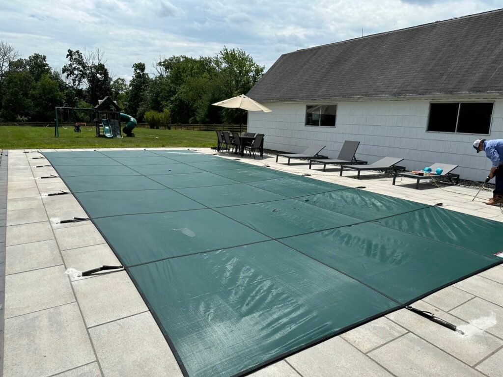 mesh pool cover for winter professionally fitted.