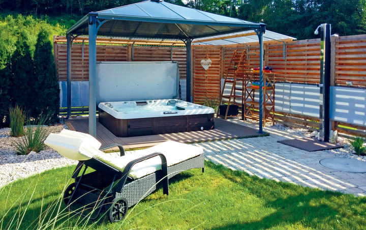 hot tub enclosure with wood privacy walls and gazebo