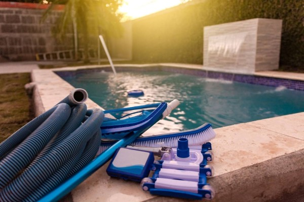 swimming pool maintenance tools - a pool with a vacuum cleaner and tools