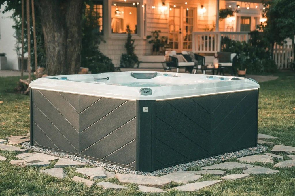sundance spas hot tub in a backyard at dusk